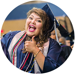 Outstanding Value - Photo of student smiling at graduation ceremony